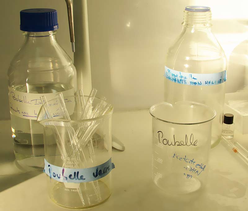Photo of several beakers and glass bottles