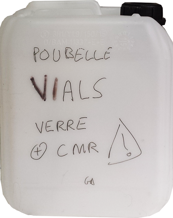 Picture of a plastic container with the handwritten words "VIALS GLASS + CMR".